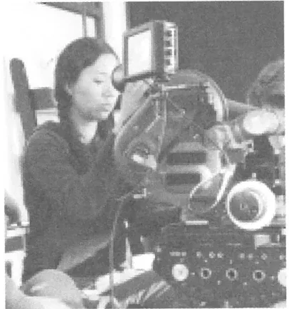 Isabel Luna operating a film camera on set